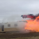 Stunt driver the Flying Farmer jumps over a burning caravan